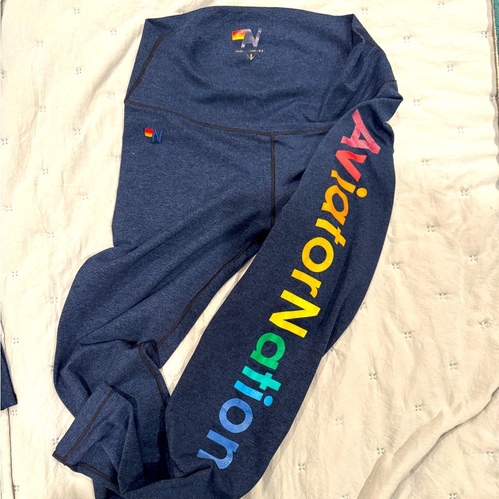 Aviator Nation navy blue leggings with brand name in rainbow down legs, size M
